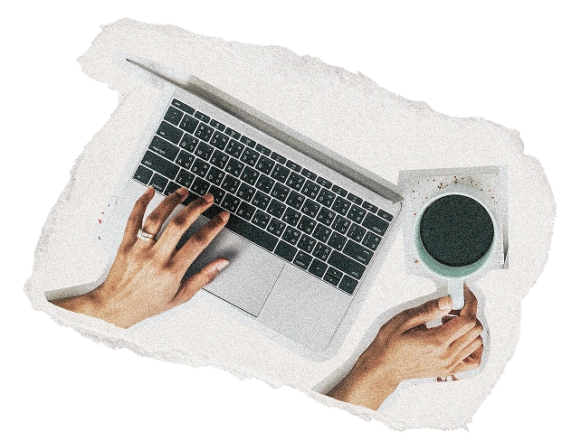 Professional working on a laptop with coffee at a desk